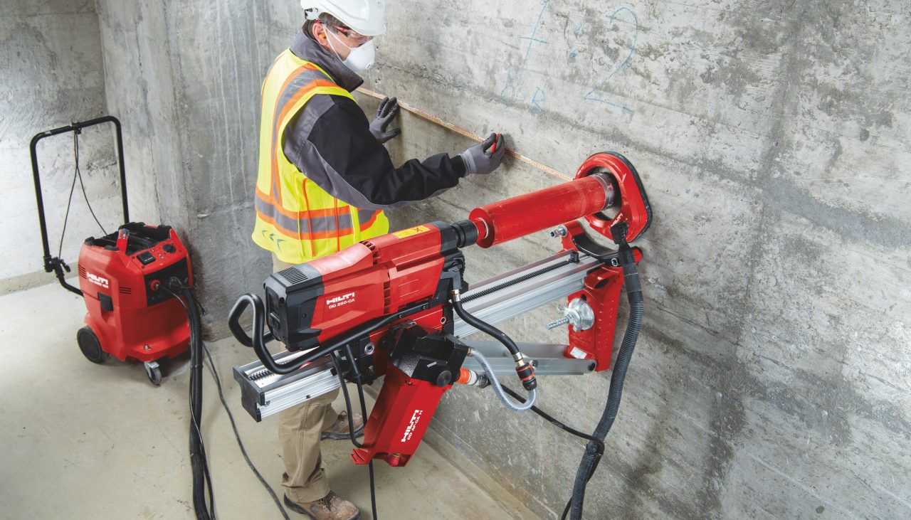 Worker on jobsite operating a diamond drill