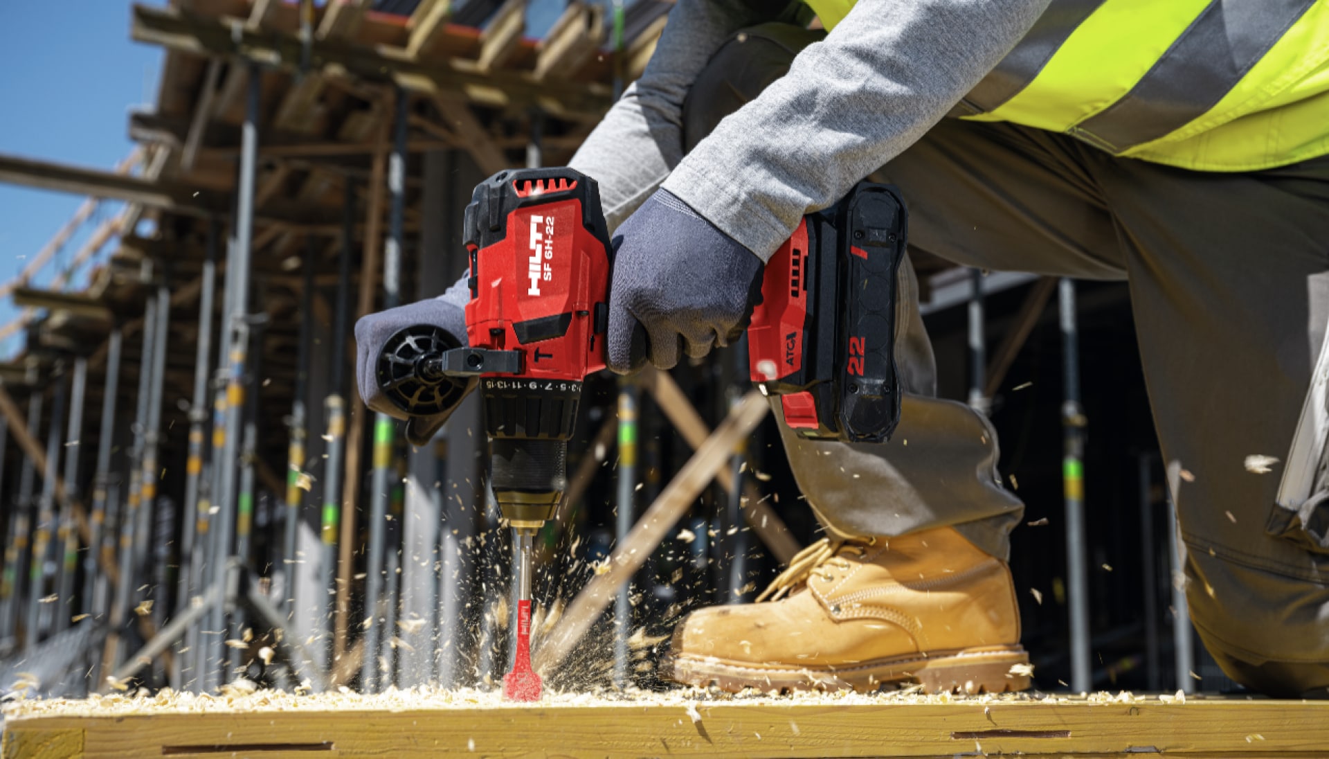 Worker using SF 6H-22 3rd generation Nuron cordless hammer drill driver with B22-85 battery and spade bit in wood