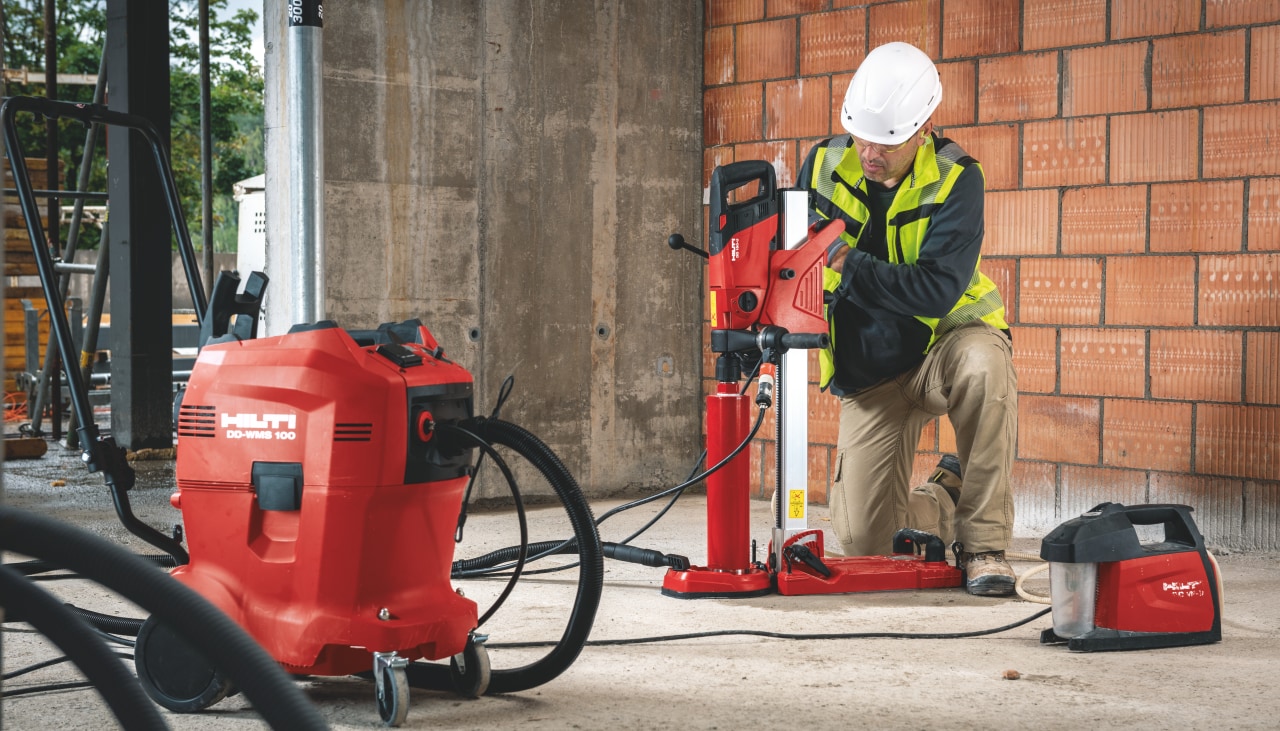 Worker on jobsite operating a diamond drill